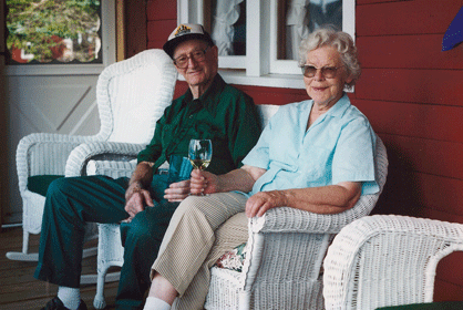 Elmont and Audrey Jackson enjoy a glass of wine on the porch of one of Jackson's pet-friendly log cabins